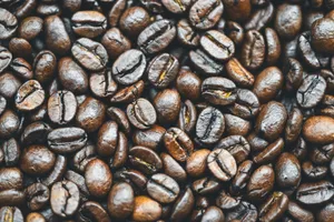 Close-up macro photography of roasted coffee beans showcasing rich textures and dark brown tones. jigsaw puzzle
