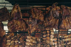 Close-up of meats roasting on a traditional Argentine parilla grill in Uribelarrea. jigsaw puzzle
