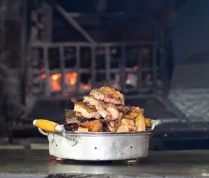 Delicious traditional Uruguayan Asado served hot, showcasing succulent grilled meats by a wood-fired grill. jigsaw puzzle