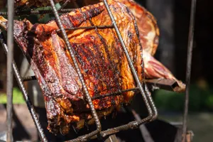 Close-up of juicy grilled meat sizzling on an outdoor barbecue grill. jigsaw puzzle