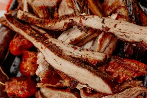 Close-up of grilled beef and sausages from an Argentine asado, showcasing richly seasoned meats. jigsaw puzzle