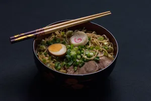 Delicious bowl of Japanese ramen with egg and scallions, topped with chopsticks. jigsaw puzzle