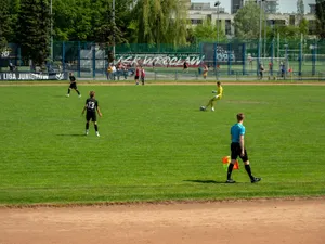 Youth soccer game at Wrocław sports field on a sunny day with players and referee in action. jigsaw puzzle