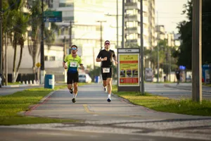 Two men jogging on an urban path, wearing sportswear during a sunny day run. jigsaw puzzle