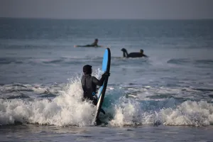 Surfers enjoy water sport in the ocean waves of Pays de la Loire, France. jigsaw puzzle