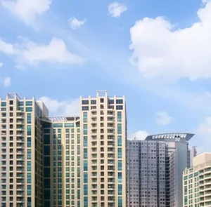 Tall modern skyscrapers with clear blue sky backdrop, serene urban scene. jigsaw puzzle