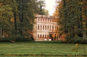 Charming historic palace facade surrounded by lush trees in Zatonie Park, Lubusz Voivodeship, Poland. jigsaw puzzle