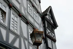 Detailed view of traditional Fachwerk buildings in Fritzlar, Germany, with a vintage lantern. jigsaw puzzle