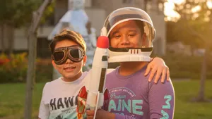 Two boys enjoying imaginative play as astronauts outdoors at sunset, creating joyful childhood memories. jigsaw puzzle