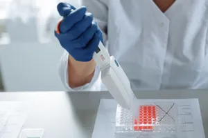 Close-up of a scientist using a pipette in a lab with a focus on sterile procedures. jigsaw puzzle