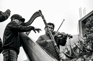 Black and white image of street musicians performing with harp and violin. Outdoors setting. jigsaw puzzle