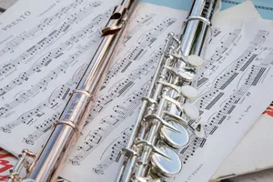 Detailed view of flutes resting on musical sheets, showcasing intricate details. jigsaw puzzle
