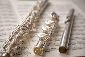 Elegant silver flutes resting on sheet music, showcasing classic musical beauty. jigsaw puzzle