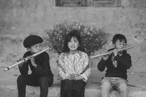 Three children playing flutes outdoors, expressing joy and tradition in this black and white image. jigsaw puzzle