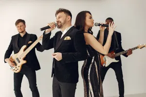 A stylish band performing on stage with singers and musicians captured in dynamic poses. jigsaw puzzle