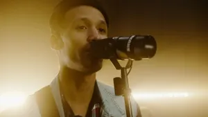 Close-up of a male singer performing passionately with a microphone on stage lighting. jigsaw puzzle