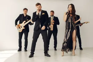 A stylish music band performing with vocalists and musicians in formal attire. jigsaw puzzle