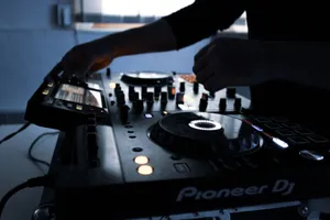 Close-up of DJ equipment in action during a mixing session in a dimly lit room. jigsaw puzzle