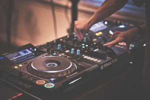 DJ's hands adjusting a mixer during a live music performance. jigsaw puzzle