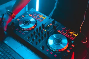 From above of unrecognizable male disk jockey standing near DJ jog wheels near laptop while playing music in modern nightclub jigsaw puzzle
