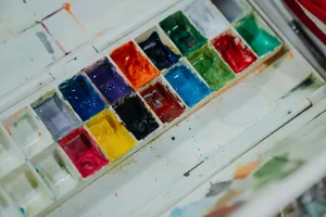A vibrant and colorful palette of watercolor paints arranged in a neat grid. jigsaw puzzle