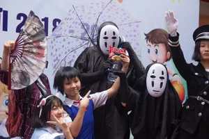 Group of people in cosplay costumes posing at an anime-themed celebration with props and masks. jigsaw puzzle