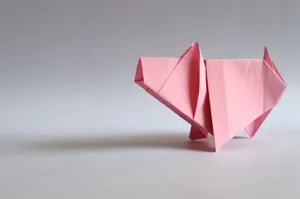 A pink paper origami pig, showcasing traditional Japanese folding art. jigsaw puzzle