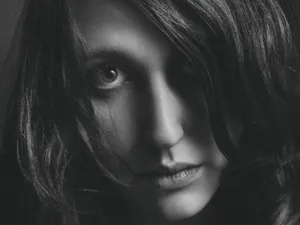 Close-up black and white portrait capturing intense emotions of a woman. jigsaw puzzle
