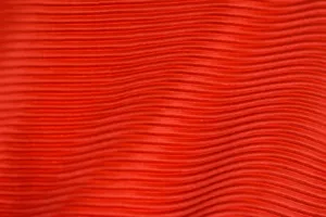 Close-up of red fabric with wavy lines and detailed texture, ideal for backgrounds. jigsaw puzzle