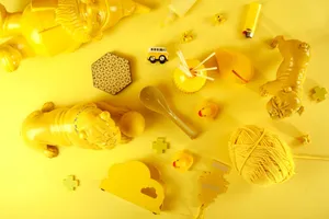 From above of composition of different yellow toys and decorations placed on light yellow surface in studio jigsaw puzzle