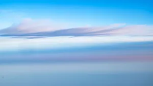 A stunning abstract view of colorful clouds and blue sky from an airplane over New York. jigsaw puzzle