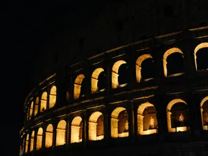 Colosseum illuminated at night against dark sky jigsaw puzzle