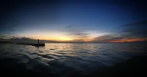 a boat floating on top of a large body of water jigsaw puzzle