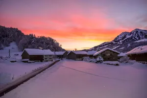 snow covered houses and trees during sunset jigsaw puzzle