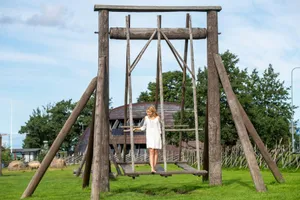 Woman in white dress on large wooden swing jigsaw puzzle