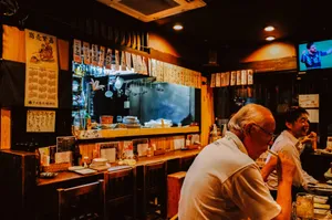 People sitting at a bar in a dimly lit restaurant. jigsaw puzzle