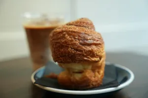 Croissant pastry with a chocolate drink on a table jigsaw puzzle