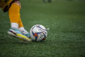 a person kicking a soccer ball on a field jigsaw puzzle