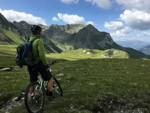 man riding bicycle on top of mountain jigsaw puzzle