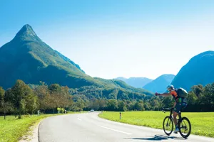 man riding bicycle on road during daytime jigsaw puzzle