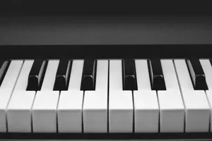 a black and white photo of a piano jigsaw puzzle