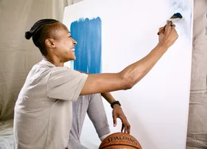 man in gray polo shirt holding brown wooden basketball jigsaw puzzle