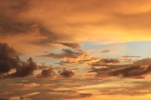 A breathtaking view of dramatic golden clouds during sunset with a serene sky. jigsaw puzzle