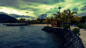 Scenic tropical beach with palms and huts, perfect for an idyllic vacation getaway. jigsaw puzzle