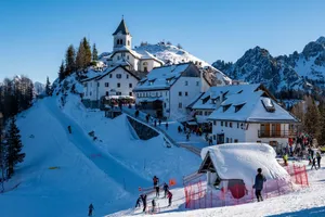 Snow-covered ski resort in Friuli Venezia Giulia with skiers enjoying a sunny winter day. jigsaw puzzle